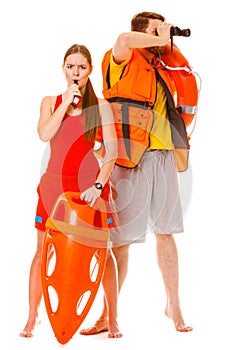 Lifeguards in life vest with ring buoy whistling.