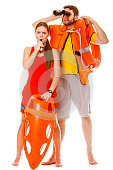 Lifeguards in life vest with ring buoy whistling.