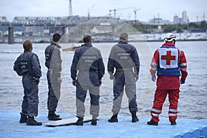 Lifeguards and paramedic standing on a pier waiting for sufferers. Rescue operations