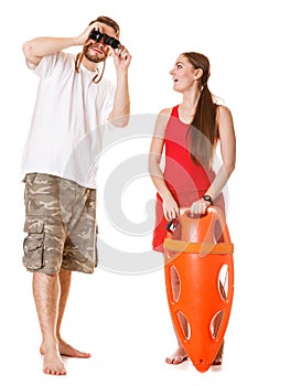 Lifeguards with rescue buoy and binoculars.