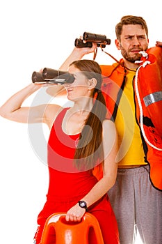 Lifeguards with rescue ring buoy and life vest.