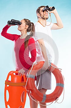 Lifeguards with rescue and ring buoy lifebuoy.