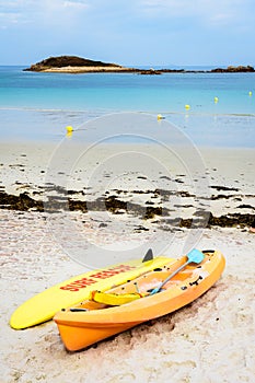 Lifeguards rescue surfboard and kayak lying on the beach