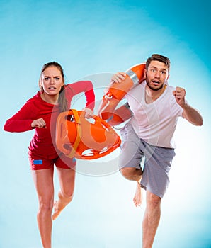 Lifeguards running with equipment