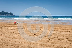 Lifeguards seats on the beach near the ocean