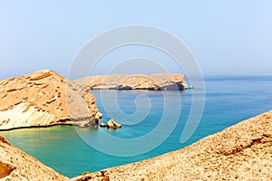 Lifeless rocky islands under scorching sun off the coast of Oman in the Gulf of Oman