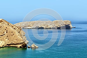 Lifeless rocky islands under the scorching sun off coast of Oman in the Gulf of Oman