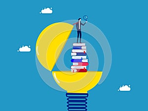 Lifelong learning and research. Businessman with a magnifying glass standing on a stack of books in a light bulb