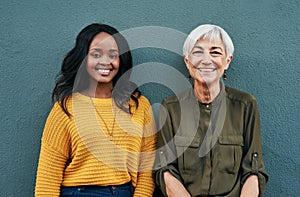 Lifes all about learning from each other. Portrait of a cheerful mature and young businesswoman posing together against