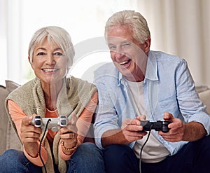Lifes better in 2 player. a senior couple playing video games.