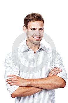 Lifes pretty good at the moment. Studio shot of a young man standing with his arms crossed against a white background.