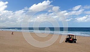 Lifesaver driving buggy on the beach