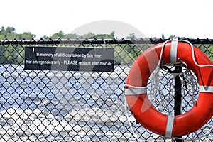Lifesaver on a fence with commemorative sign text