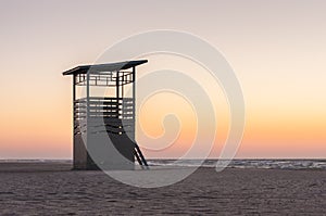 Lifesaver patrol tower on the Coast. Sunset time, summer travel background