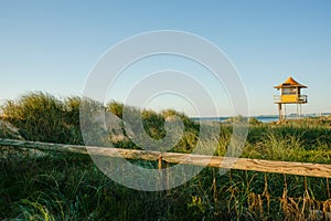 Lifesavers lookout on Surfer`s Paradise beach beyond dunes and marram grass photo