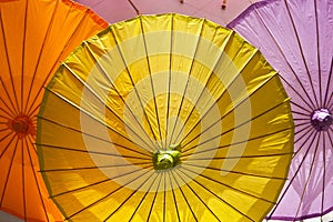 A yellow lifesize cocktail drink umbrella and other colors photo