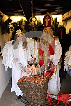 Lifesize figures of Saint Nicholas and Angel with basket photo