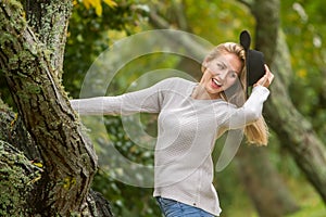 Lifestile outdoor portrait of young beautiful woman on natural b