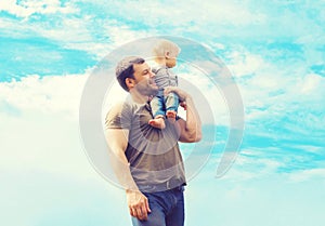 Lifestyle atmospheric photo happy father and son child outdoors over blue sky