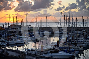 Lifestyle background, yachts and sail boats in ocean harbour on tropical island on sunrise