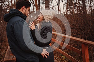 Lifestyle capture of happy couple drinking hot tea outdoor on cozy warm walk