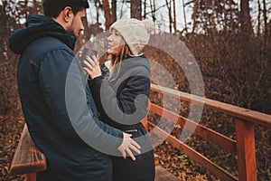 Lifestyle capture of happy couple drinking hot tea outdoor on cozy warm walk