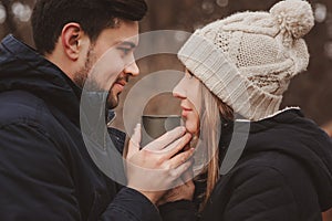 Lifestyle capture of happy couple drinking hot tea outdoor on cozy warm walk in forest