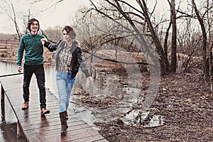 Lifestyle close up outdoor portrait of young happy loving couple walking in early spring