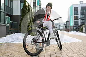 Lifestyle concept, Caucasian woman with a bicycle near the house in winter