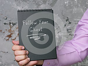 Lifestyle concept about Follow Your Ghost with phrase on the sheet