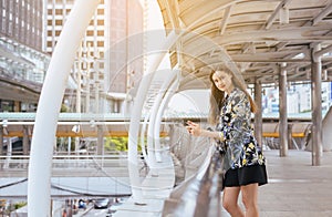 Lifestyle concept,Portrait beautiful woman using cellphone and walking in the city,Female confidence happy and smiling
