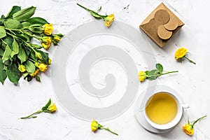 Lifestyle concept with tea and roses on home desk top view mock-up