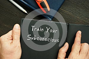 Lifestyle concept about Train Your Subconscious with phrase on the piece of paper
