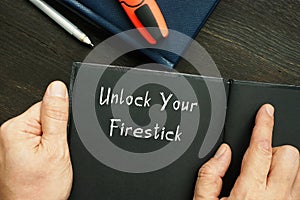 Lifestyle concept about Unlock Your Firestick with inscription on the piece of paper