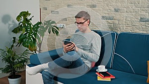 Lifestyle concept - young man working with tablet pc computer.