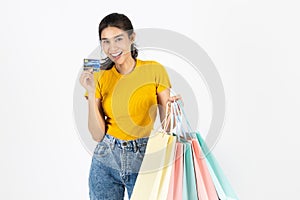Lifestyle, Consumerism, Sale and Shopping concept. Smiling young Asian woman showing credit card and lot of shopping bag over