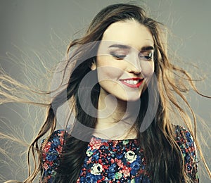Lifestyle, emotion and people concept: Beautiful happy girl with long wavy hair