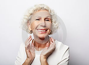 Lifestyle, emotion and people concept: Grey haired old nice beautiful laughing woman. Isolated over vwhite background
