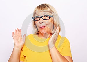 Lifestyle, emotion and people concept: old nice beautiful surprised woman. Isolated over white background.