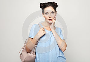 Lifestyle, emotion and people concept: Young surprised woman wearing casual
