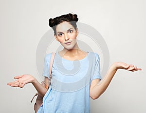 Lifestyle, emotion and people concept: Young surprised woman wearing casual