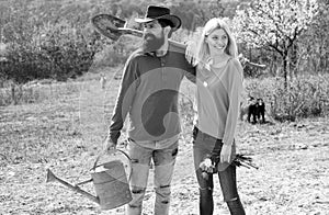 Lifestyle and family life. Eco living. A farmer and his wife standing in their field. Two people gardening in the