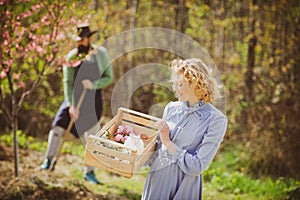 Lifestyle and family life. Image of two happy farmers with instruments. I like spending time on farm. Two people walking
