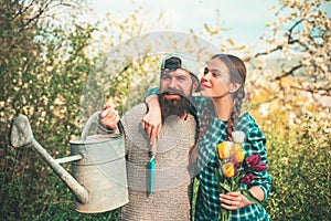 Lifestyle and family life. Two people gardening in the backyard garden. Happy Couple Farmers working with spud on spring