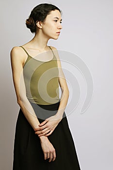 Lifestyle and fashion concept: brunette woman wearing casual clothes, posing ongrey background