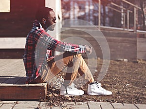 Lifestyle fashion portrait of stylish young african man