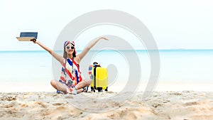 Lifestyle freelance woman raise arms relax after using laptop working on the beach.