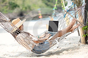 Lifestyle freelance woman using laptop working and relax on the beach.