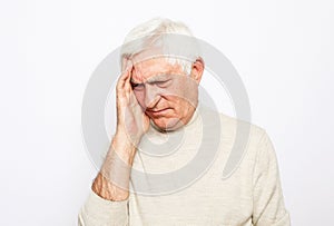 Lifestyle, health and people concept: Senior man has headache, on white background