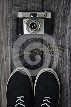 Lifestyle, hobbie, old analog photo camera, two sneakers and lavender